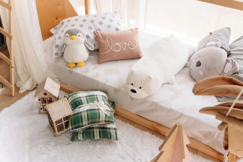 a room filled with white stuffed animals and pillows