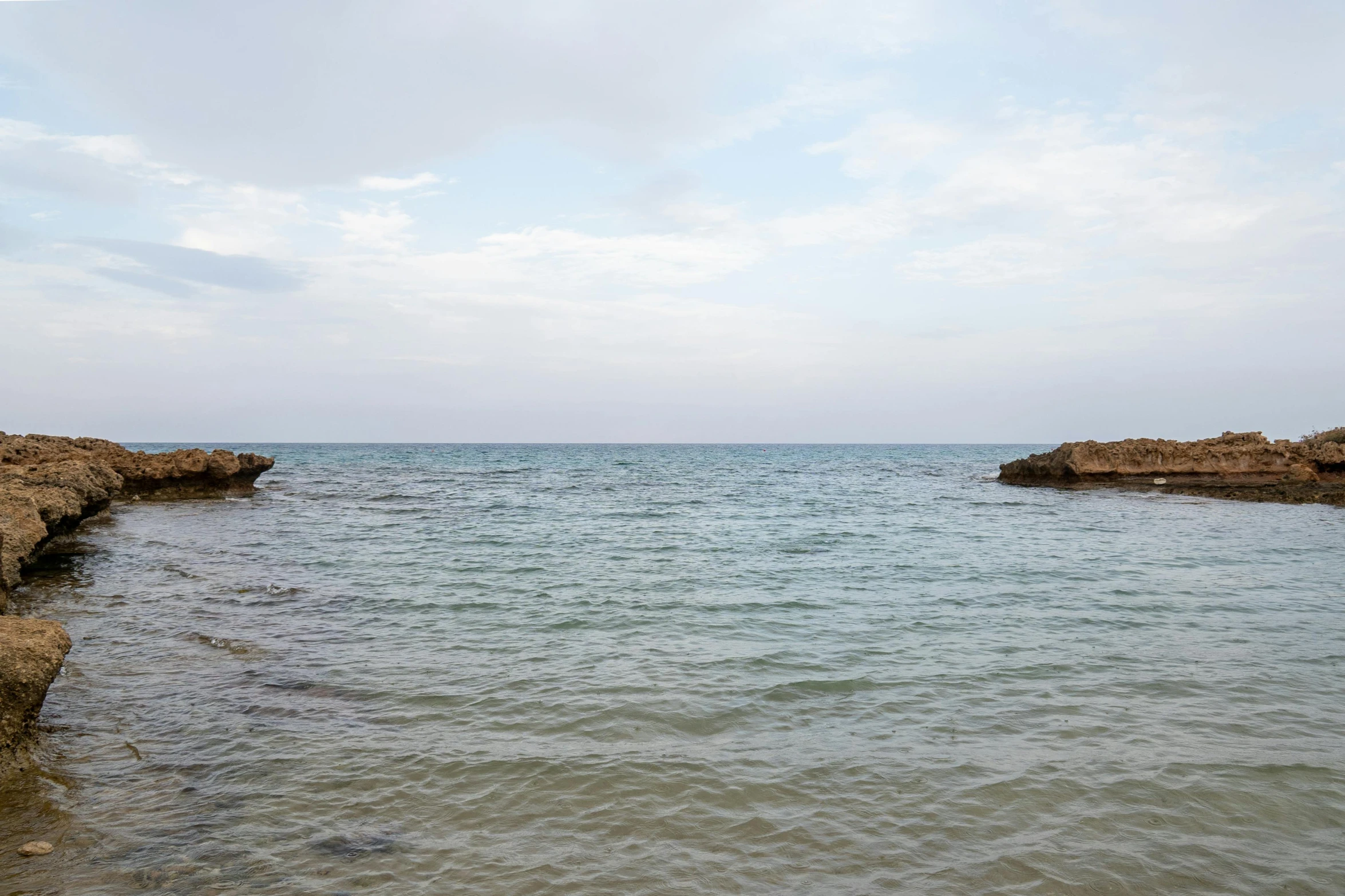 the sea is clear and blue and grey