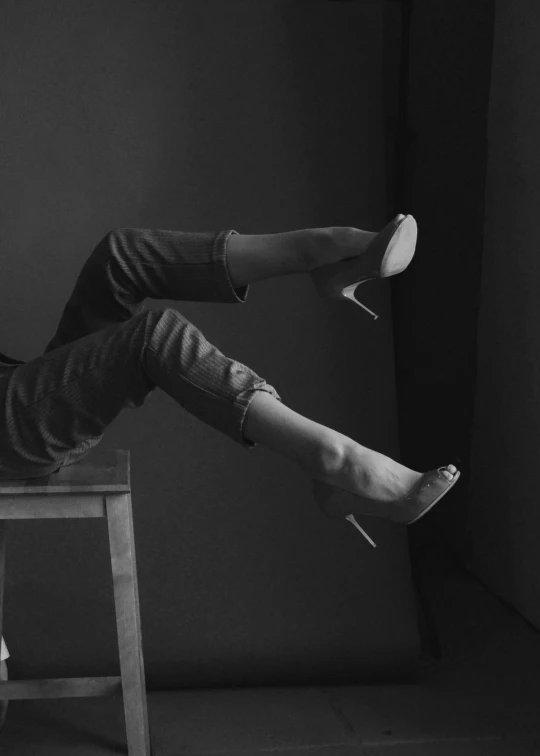 a black and white po of a woman sitting on a chair