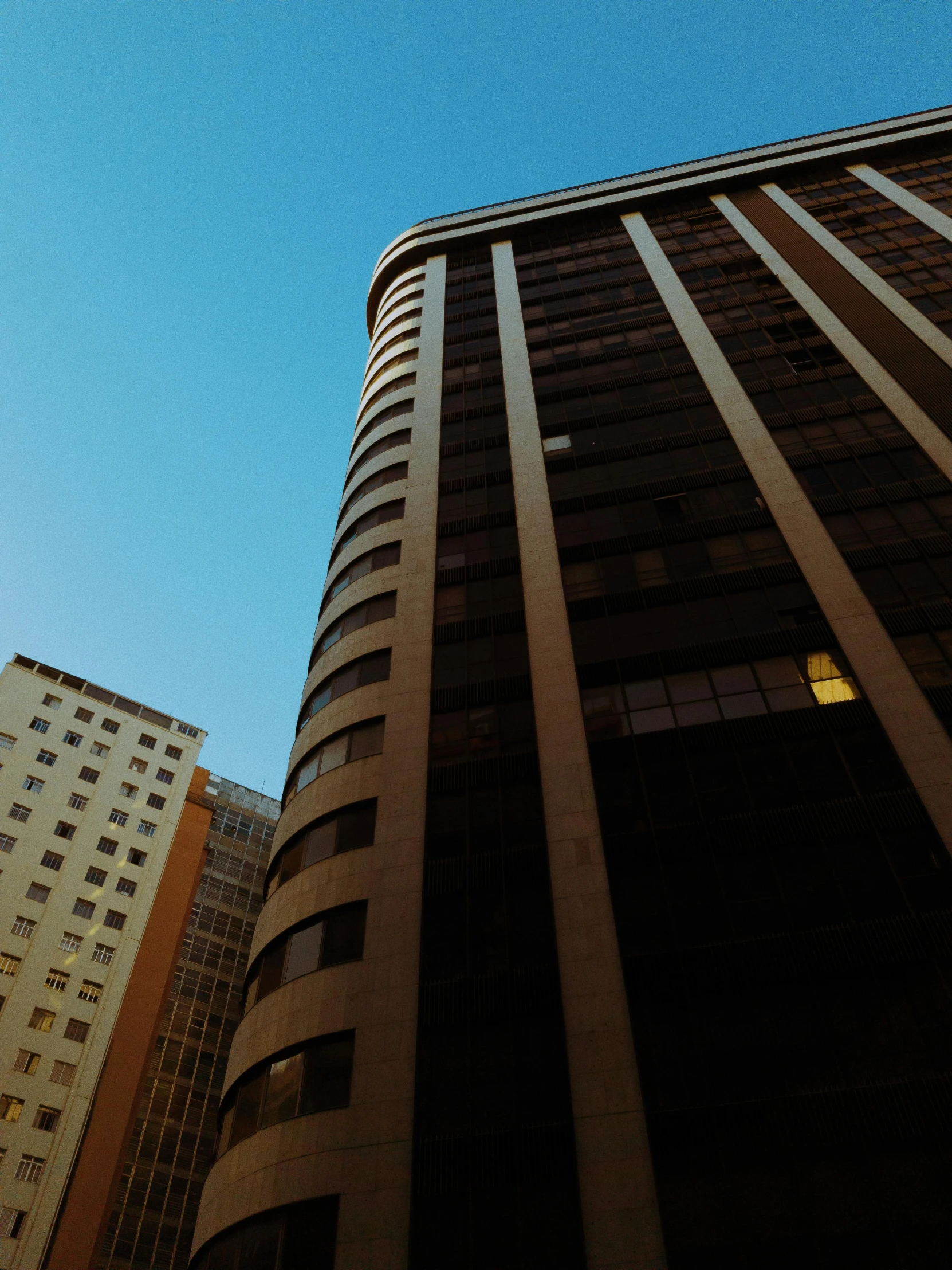 the front side of a tall building with a street sign