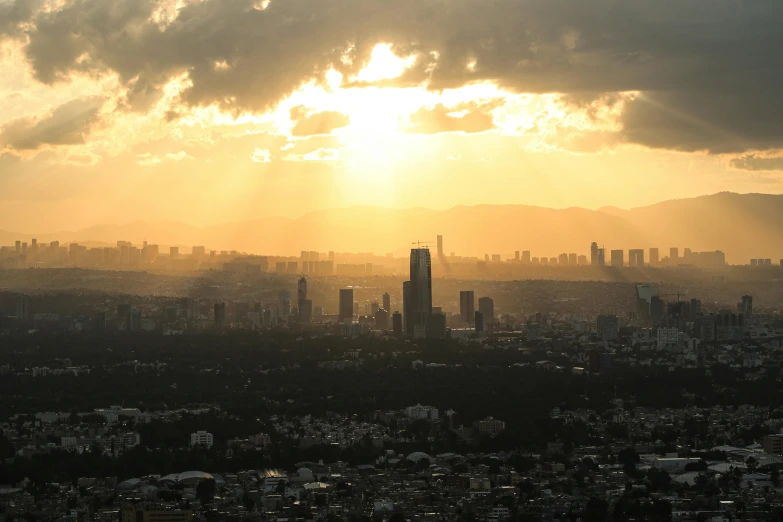 a view of a city with tall buildings with a cloudy sky