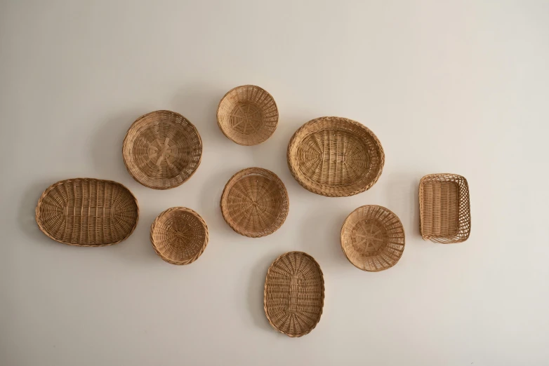 an assortment of different baskets arranged on a wall