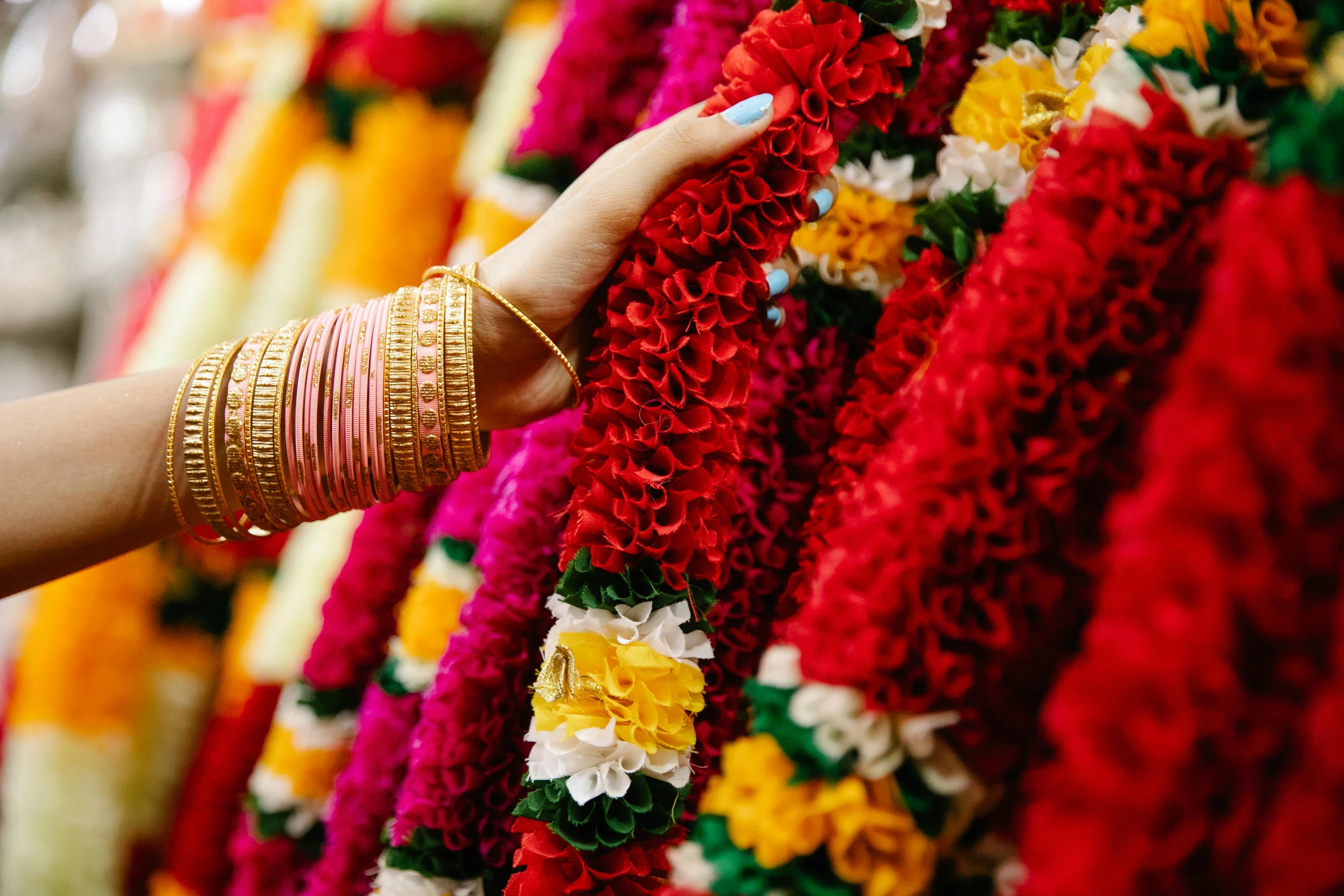 the woman is trying to buy floral garlands