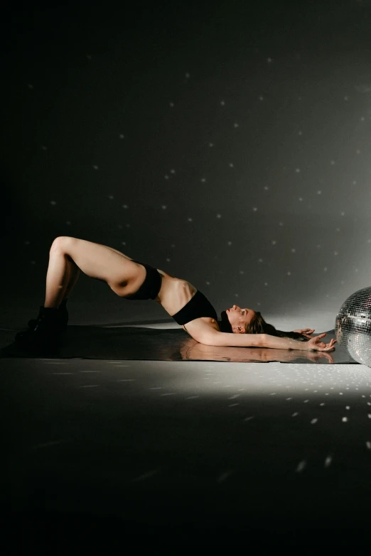 a person in black underwear and some boots laying on the ground