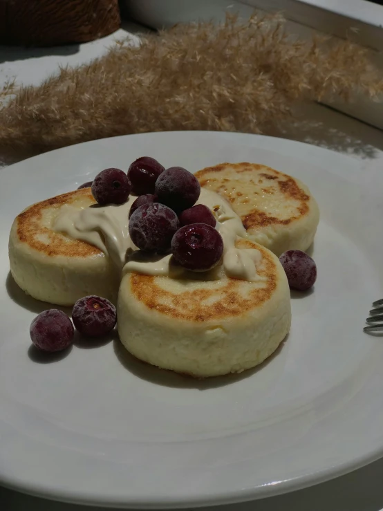 pancakes with whipped cream and berries on a plate