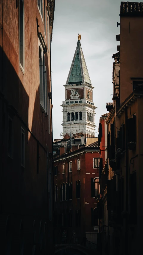 a clock tower that is sitting on the side of buildings