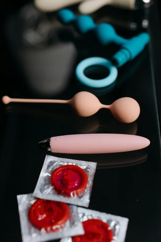 two plastic pink doughnuts in front of scissors and some medical equipment