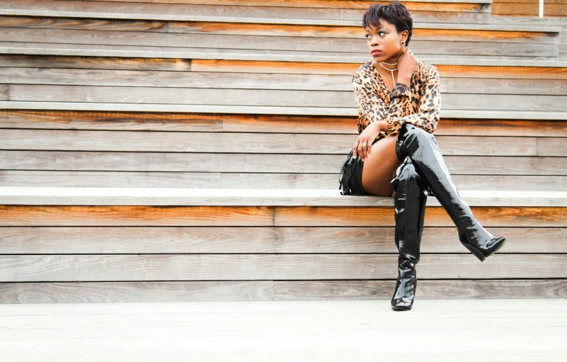 a woman sitting on the step of stairs