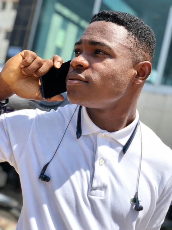 a man holding a cell phone up to his ear