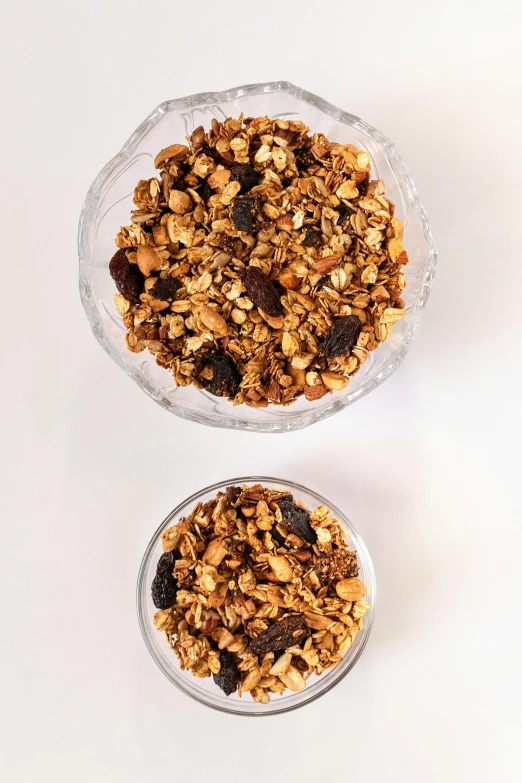 two bowls of granola on white surface