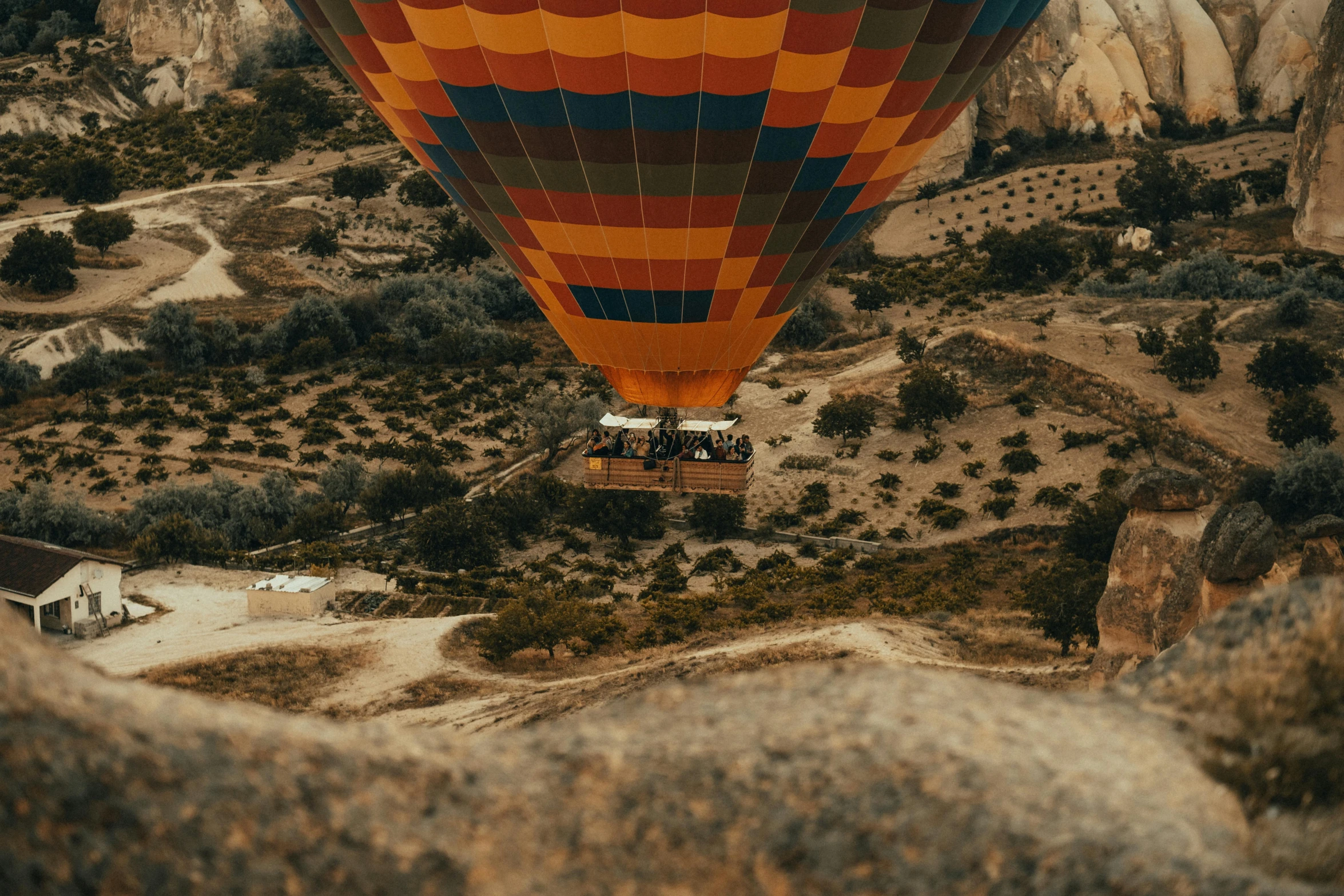 a couple of colorful  air balloons flying over land