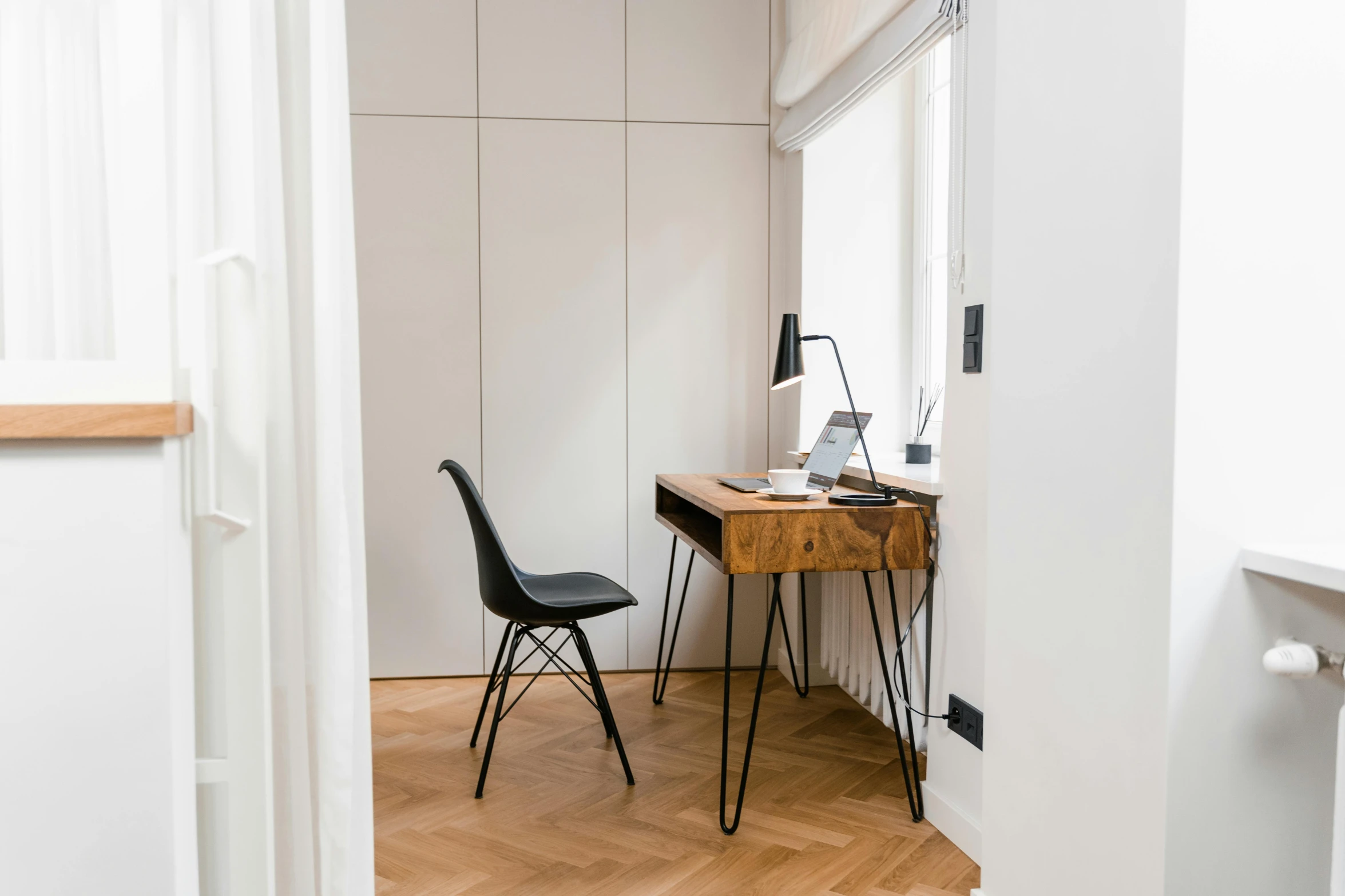 two black chairs and a table with light on them