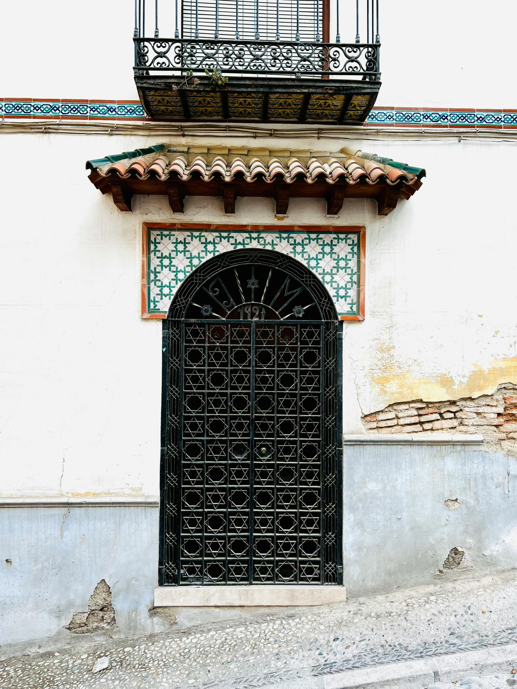 a black door in an old building with a window