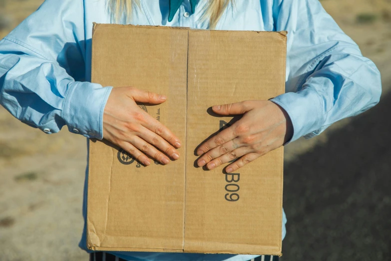 a person holding a box with soing inside