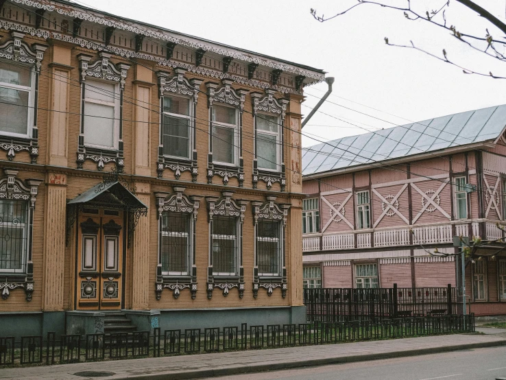 two tall wooden buildings with lots of windows on each of them