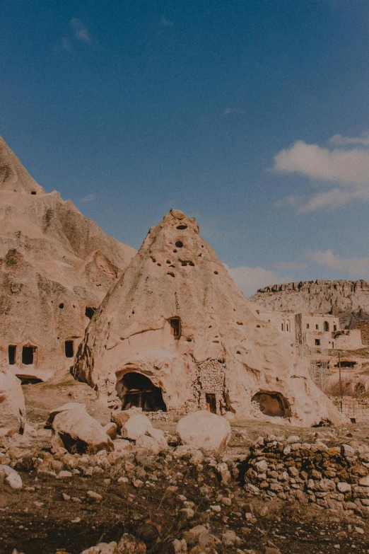 several people sitting and standing near some buildings