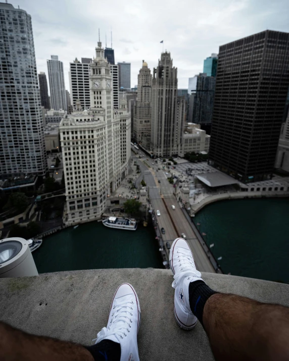 a person in sneakers on top of a tower looking down