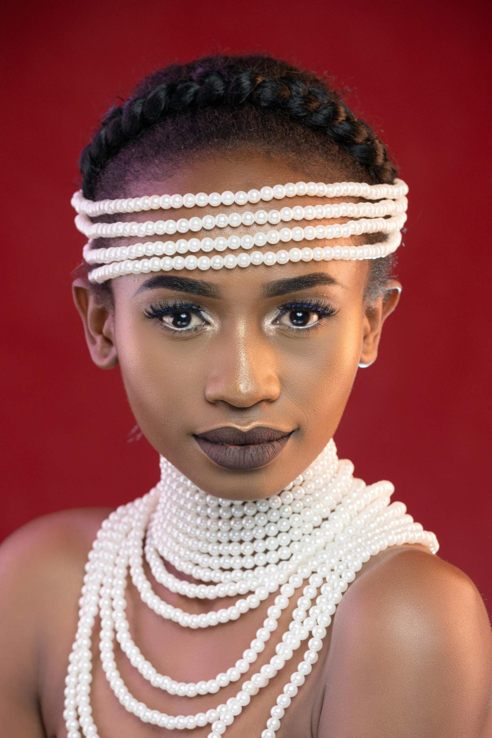 a woman wearing several strands of necklaces