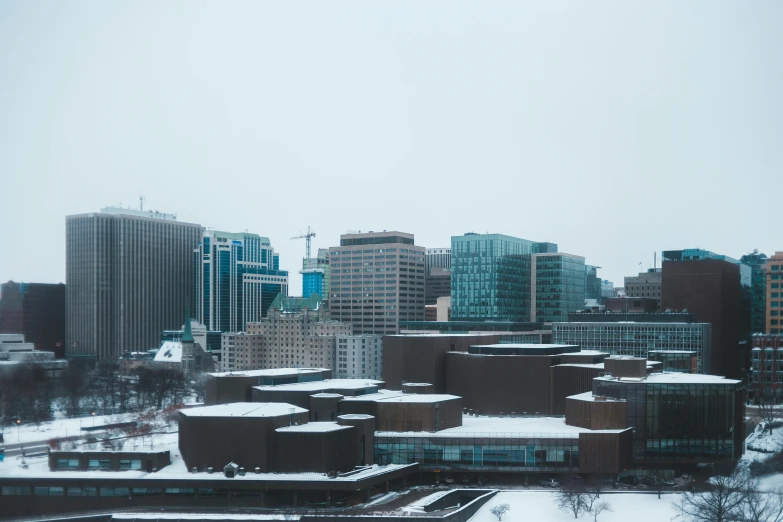 a snowy landscape with a lot of tall buildings