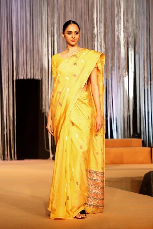 a model presents a sari creation in a fashion show