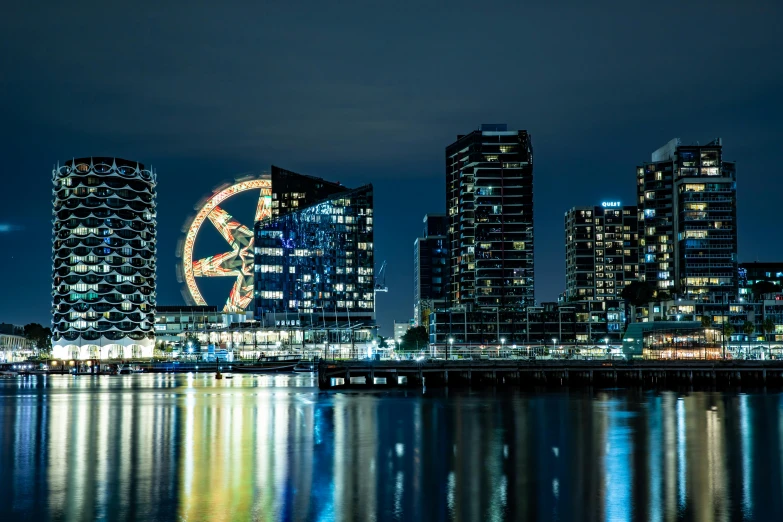 a very large ferris wheel near some big buildings