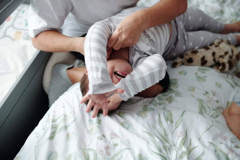 a man holds a baby boy on his lap