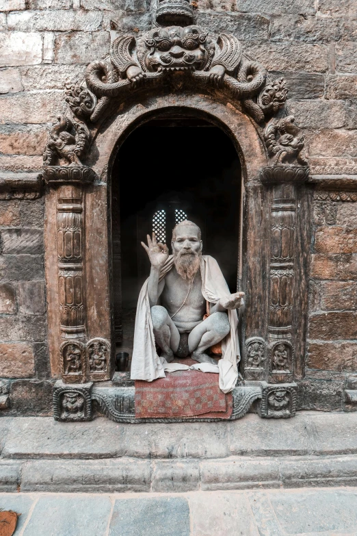 a statue of an old man sits in a window