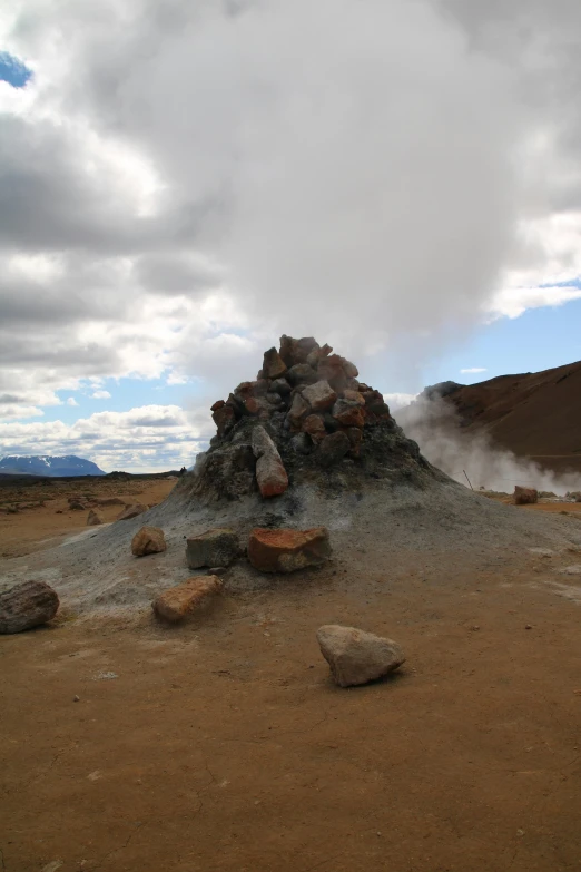 a pile of rocks on the ground covered with sand