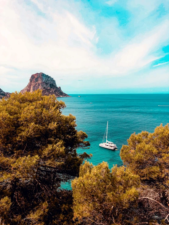 boats anchored in blue water on a sunny day