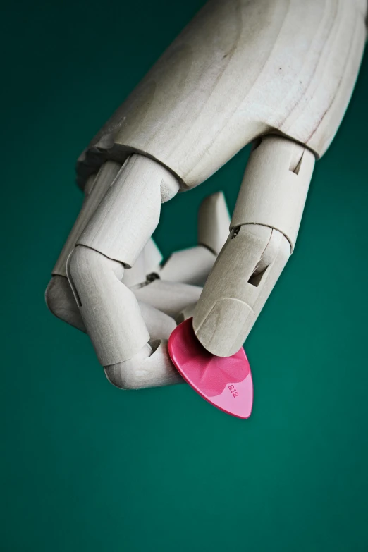 a closeup of a dummy holding a pink object