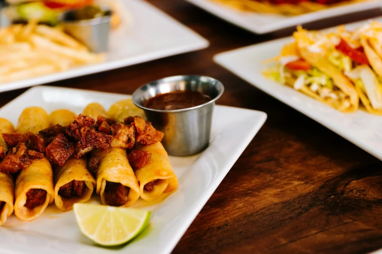 several different kinds of food on separate white plates