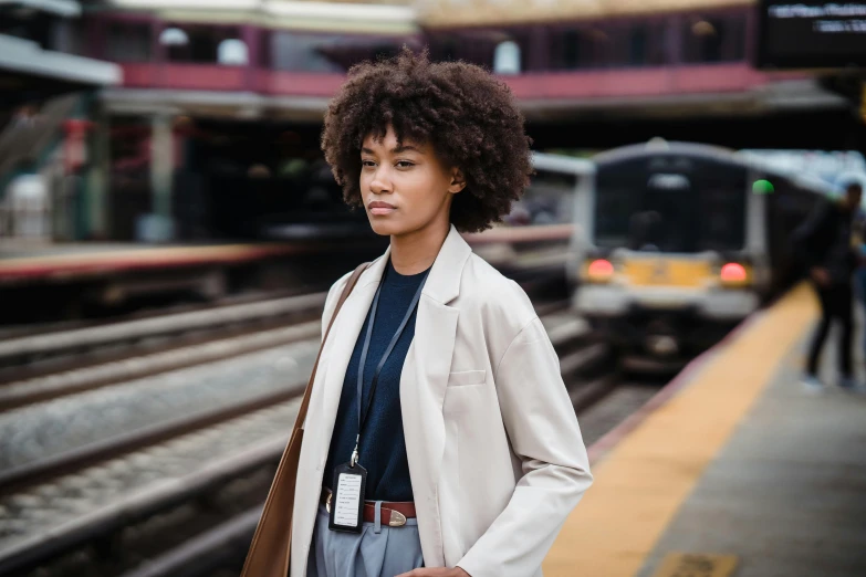 an image of a woman standing near the tracks