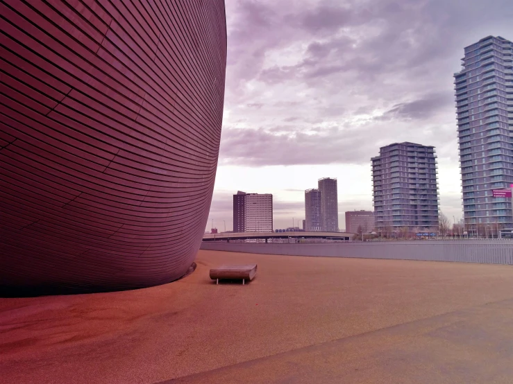 a sculpture that is by some buildings in the day