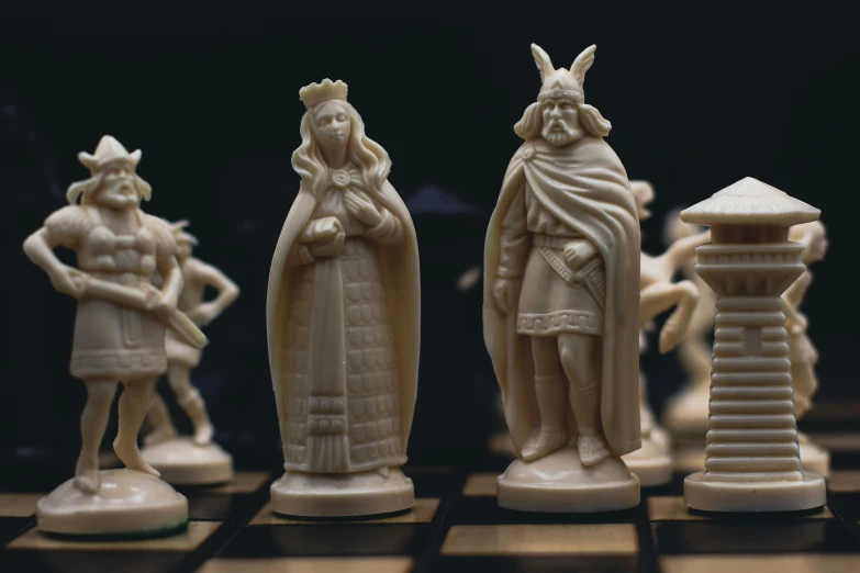 a chess board that has some statues on it