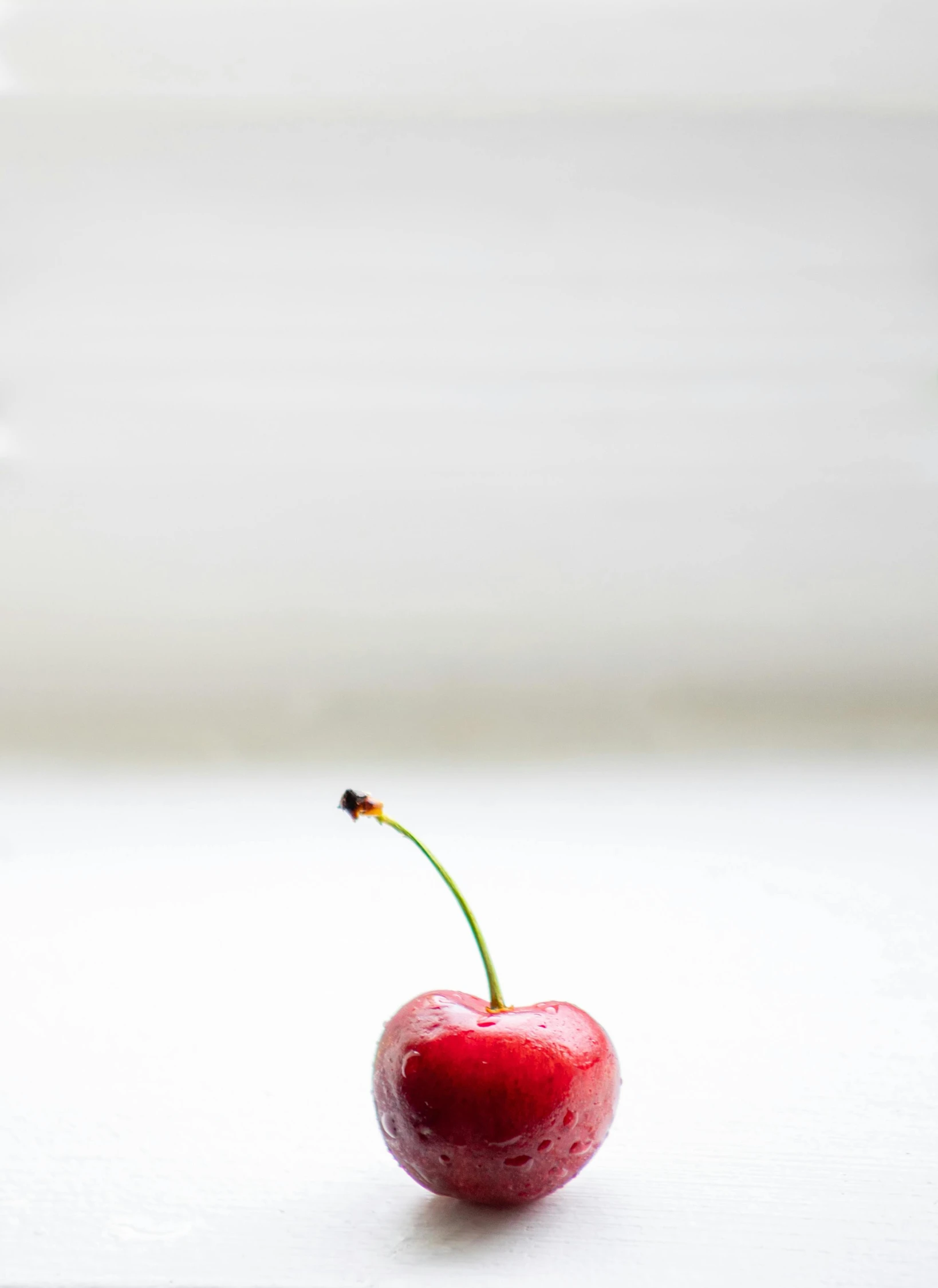 a cherry sitting on top of a white table