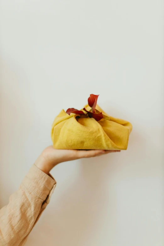 a woman holding a banana in a pouch