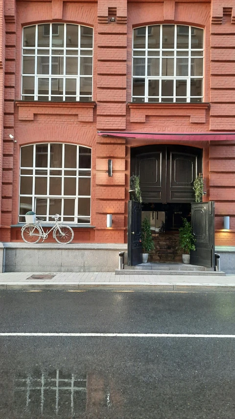 a motorcycle parked next to a large red building