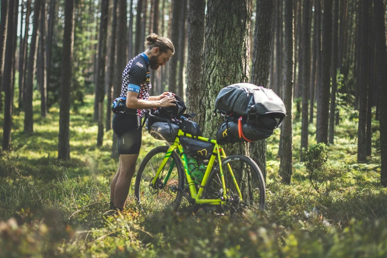 a man wearing a helmet leaning on a bike