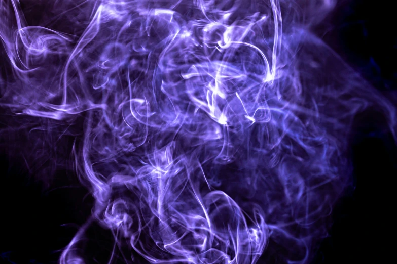 a po of purple smoke against a black background