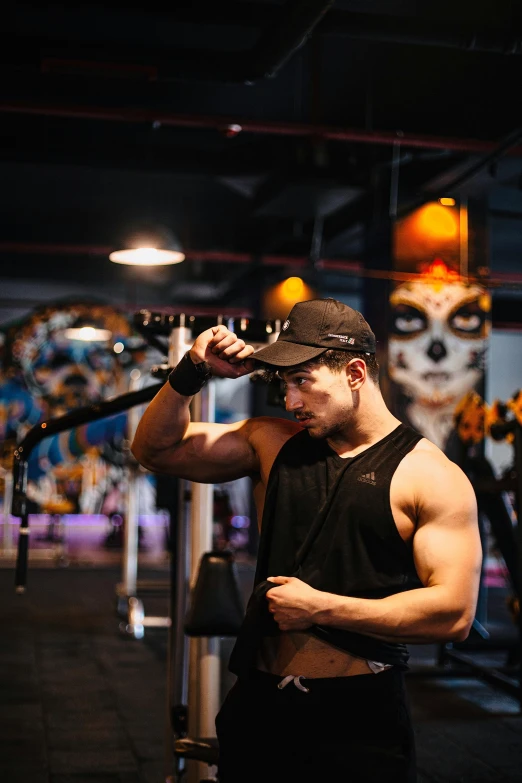 man lifting kettle at gym looking off to his left