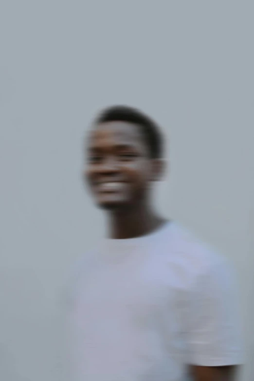 man in white shirt with cellphone blurred out to the side