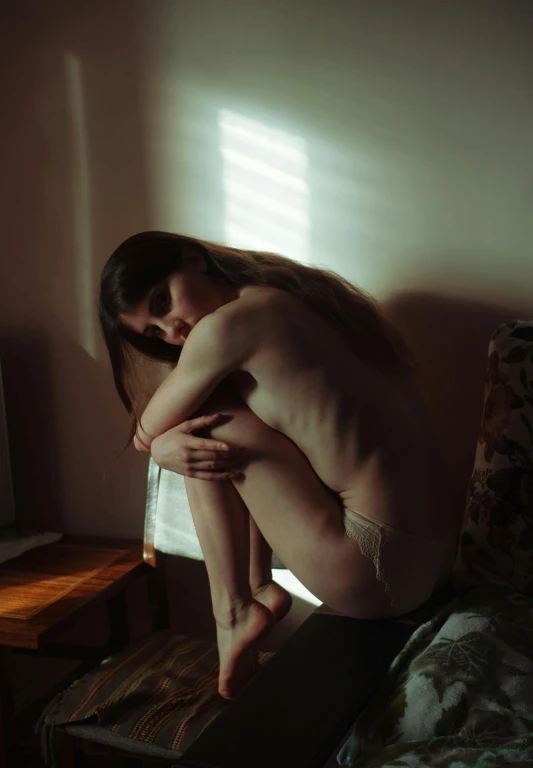  boy posing on bed near window