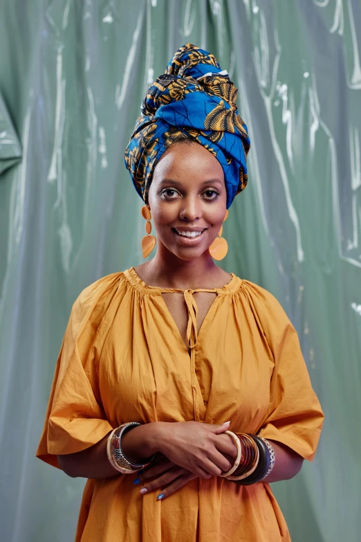 an african woman in an orange and blue dress