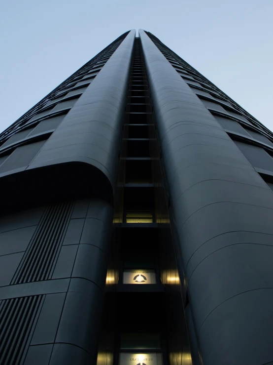 a tall building that has lights lit up at the bottom