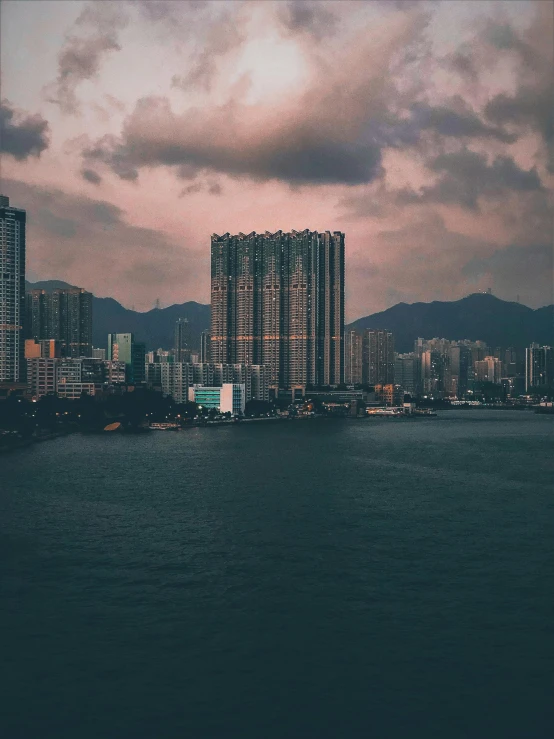 city buildings seen near the water at sunset