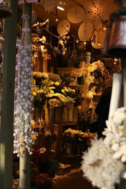 a store front filled with lots of flowers and lights