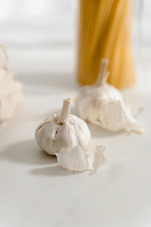 a vase with yellow hair and two garlic bulbs