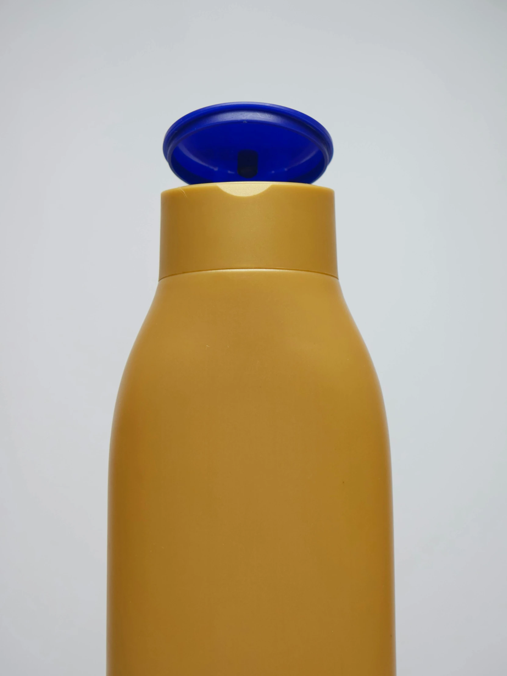 a yellow, yellow and blue bottle with a black top