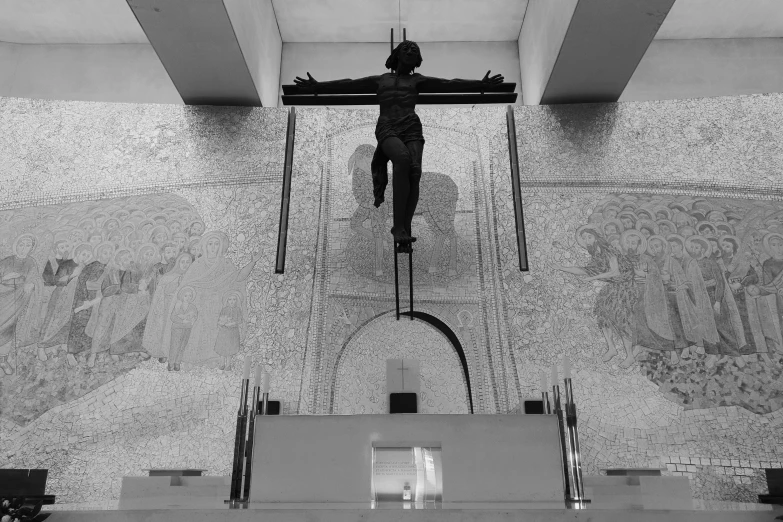 a man walking up the stairs with crucifix in his hands