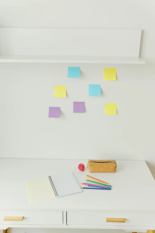 a white table topped with a pen and notebook covered in sticky notes